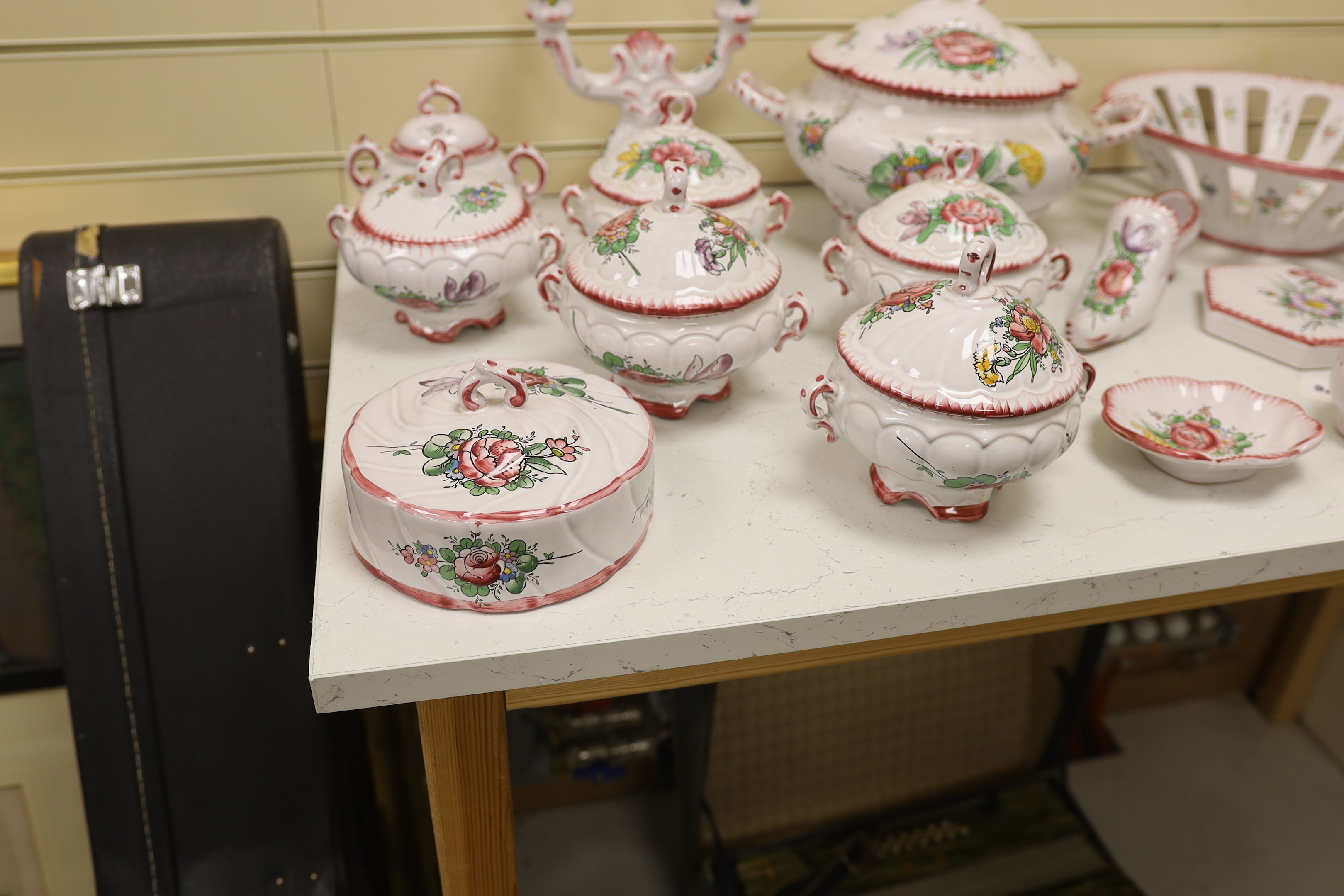 Le Renoleau Faiencerie D'Art, Angouleme, French faience tableware with floral decoration, including lidded serving pots, tureens, jugs, serving dishes, coasters, plates, candle stands, a candlestick, a water dispenser fo